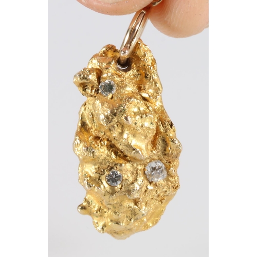 336 - Naturalist 'nugget' of gold set with three diamonds formed as a pendant, 3.1cm long, 22g gross.