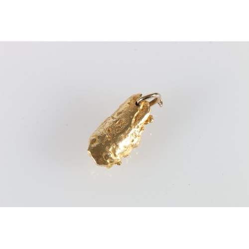 336 - Naturalist 'nugget' of gold set with three diamonds formed as a pendant, 3.1cm long, 22g gross.