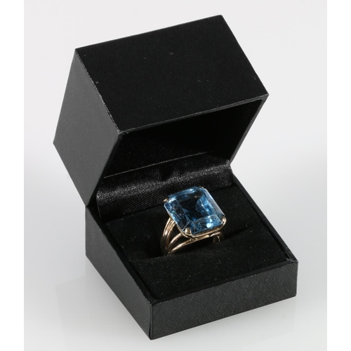 338 - 9ct gold dress ring set with large emerald cut aquamarine blue coloured stone, ring size P, 11.5g gr... 