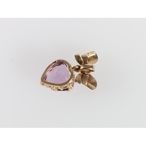 340A - 9ct yellow gold mounted pendant in the form of a bow dependant with faceted heart shaped amethyst st... 