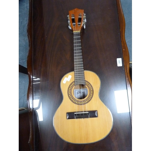 108 - Lorenzo Model N16X acoustic guitar and a Ramon Sanchez steel-strung ukulele.  (2)