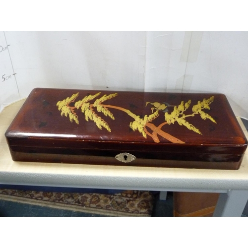 140 - Japanese lacquered sewing box, similar lacquered glove box and a musical jewellery box.  (3)