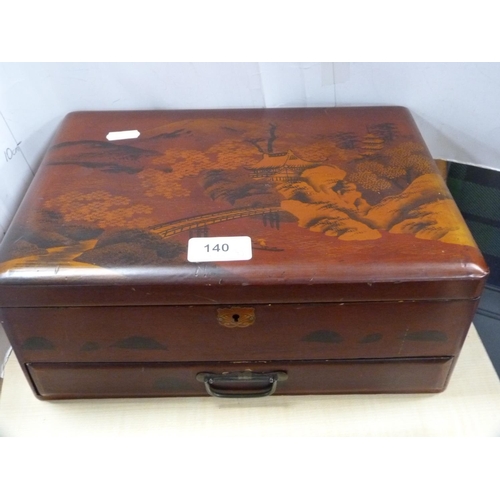 140 - Japanese lacquered sewing box, similar lacquered glove box and a musical jewellery box.  (3)