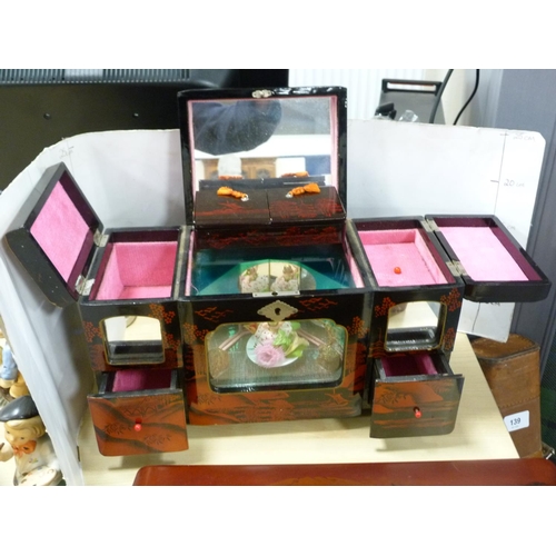 140 - Japanese lacquered sewing box, similar lacquered glove box and a musical jewellery box.  (3)