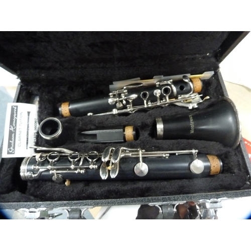 9 - Montreux clarinet, cased, a music stand and a quantity of clarinet music books.