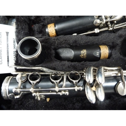 9 - Montreux clarinet, cased, a music stand and a quantity of clarinet music books.