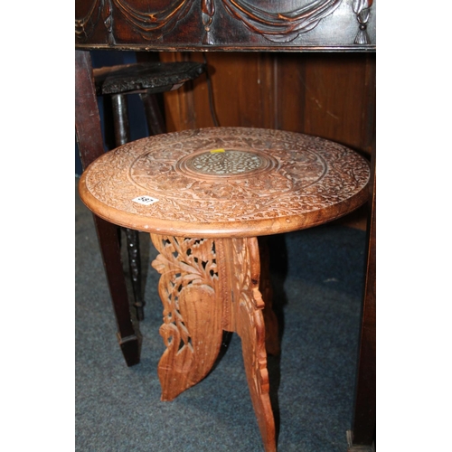 587 - Heavily carved foliate folding occasional table, 47cm high.