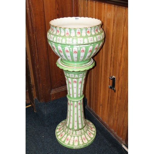 601 - Ceramic pedestal jardiniere, with floral decoration on green ground, 93cm high.