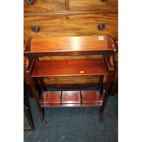 613 - Antique mahogany book trough, raised on castors, with plaque 'Army & Navy CSL maker', 53cm wide.