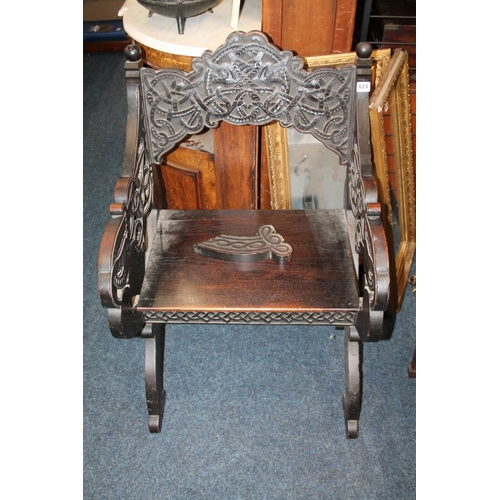 624 - Heavily carved oak Gothic revival open armchair.