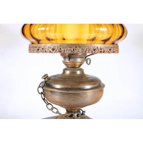 324 - Antique style paraffin lamp converted to an electric table lamp with amber coloured glass shade, rai... 