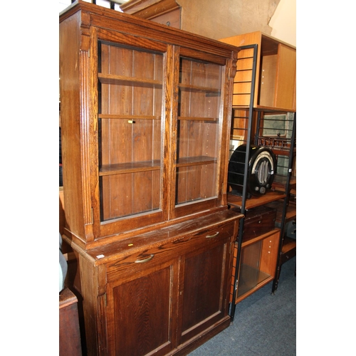 638 - Oak two section cabinet bookcase, the top with two glazed doors above cupboard base, 110cm x 200cm.