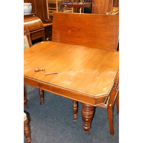 639 - Victorian oak dining table, with one additional leaf, and table winder.