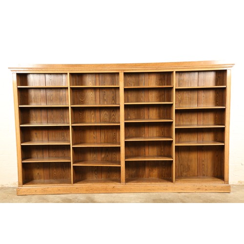 475 - Early 20th century oak open bookcase, with adjustable shelving in four compartments, length 310cm, w... 