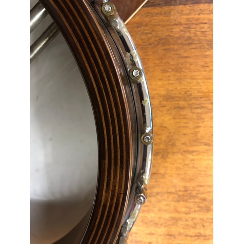 264 - A Saga 5 string Banjo, with Saga in mother of pearl on headstock, overall length 97 cm in lined and ... 