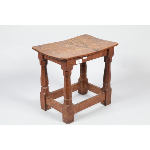 452 - Robert Mouseman of Kilburn oak stool, the adzed saddle seat on octagonal chamfered legs united by pl... 