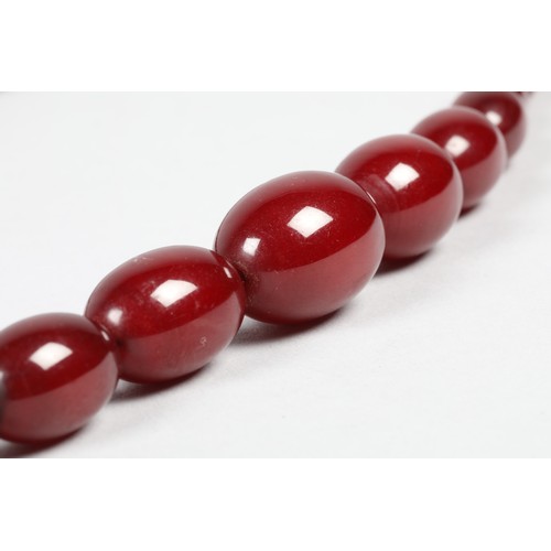 112 - Cherry amber bead necklace, length 67cm, largest bead 25mm, total weight 44g