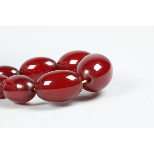 112 - Cherry amber bead necklace, length 67cm, largest bead 25mm, total weight 44g