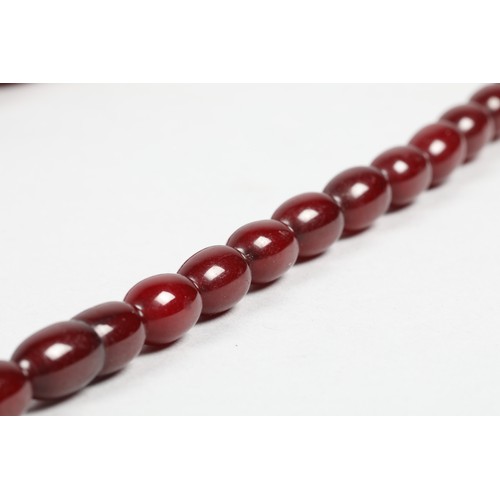 112 - Cherry amber bead necklace, length 67cm, largest bead 25mm, total weight 44g