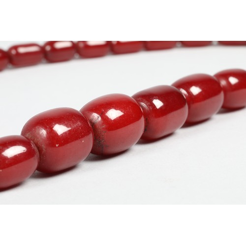 113 - Cherry amber bead necklace, length 75cm, largest bead 21mm, total weight 70g