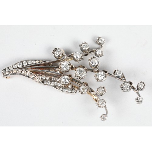 79 - Diamond floral brooch, unmarked metal set with graduated old cut diamonds, ranging from 0.33 carats ... 