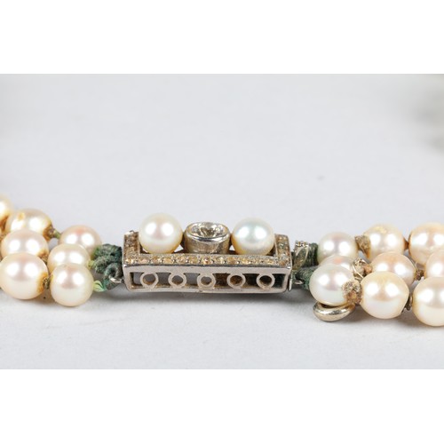 116 - Ladies double strand pearl necklace, with white metal diamond set clasp, 0.33 carats