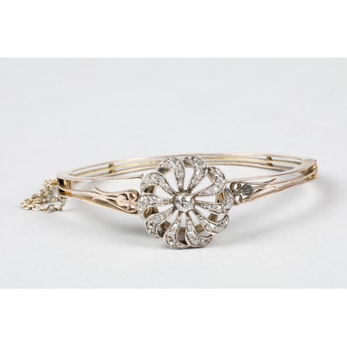 74 - Diamond set bangle, pierced unmarked stiff bangle, with a circular diamond encrusted mount, centre 0... 