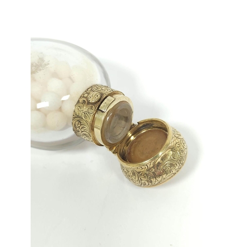 12 - Mid 19th century plain glass smelling salts bottle with engraved and initialled gold sprung cap, 9.5... 