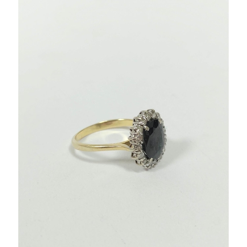 149 - Diamond and sapphire oval cluster ring with small brilliants in gold, '18ct', size 'P'.   