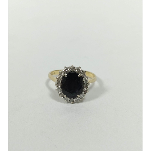 149 - Diamond and sapphire oval cluster ring with small brilliants in gold, '18ct', size 'P'.   