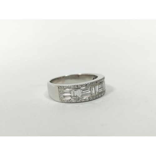 150 - Diamond eternity style ring with pairs of baguettes at right angles, in a border of small diamond br... 