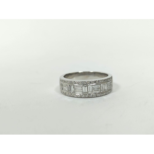 150 - Diamond eternity style ring with pairs of baguettes at right angles, in a border of small diamond br... 