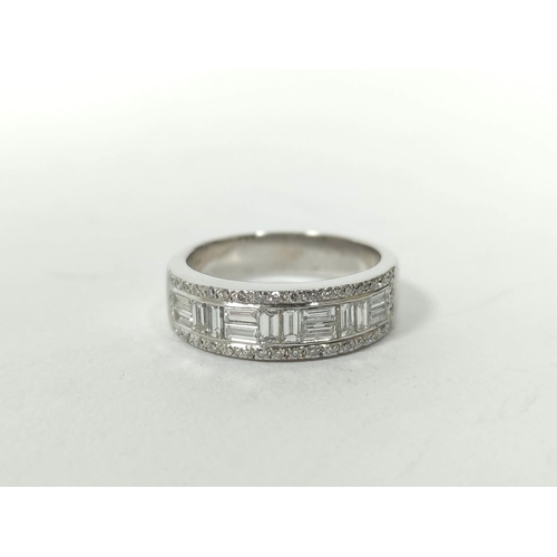 150 - Diamond eternity style ring with pairs of baguettes at right angles, in a border of small diamond br... 