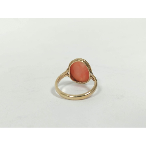 152 - Ring with oval coral cabochon in 9ct gold, size 'L½' and an opal set pin. (2) 