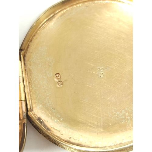 26 - Silver circular snuff box of watch case style, engine turned all over with gold joint and gilt inter... 