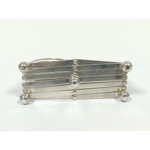 31 - Rare silver folding toast rack, for six varying slices, with loop handle, the base stamped 'R C &... 