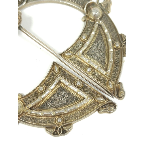 52 - Silver gilt penannular pin, unmarked with embossed Celtic motifs and plain back, 70mm.