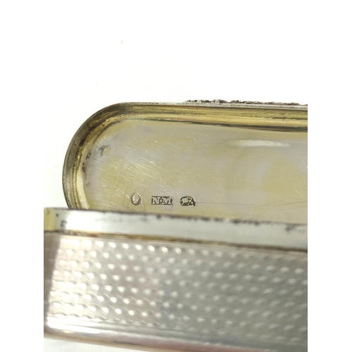 75 - Silver snuff box, rectangular with rounded ends, engine turned all over with chased thumb piece, by ... 