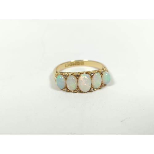 88 - Victorian opal ring with five graduated diamond points in pierced carved 18ct gold, Birmingham 1895.