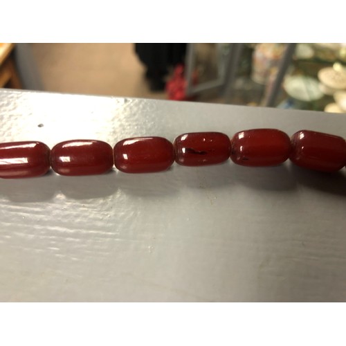 113 - Cherry amber bead necklace, length 75cm, largest bead 21mm, total weight 70g