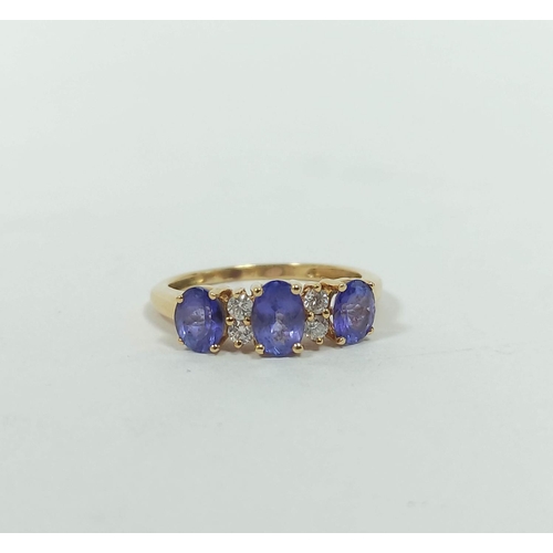 133 - Diamond and tanzanite three stone ring,. in gold, probably 18ct, size 'K½'. 