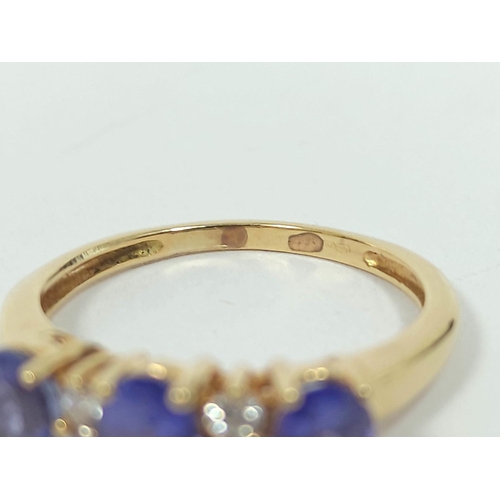 133 - Diamond and tanzanite three stone ring,. in gold, probably 18ct, size 'K½'. 