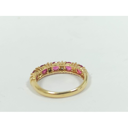 134 - Diamond and ruby five stone ring, in gold '730', size 'M½'. 