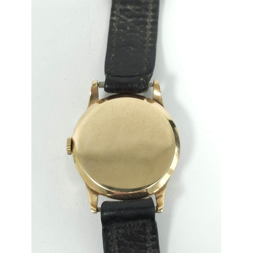 135 - Gent's 9ct gold watch for Benson, with silvered and gold dial, 1955, 31mm on strap.