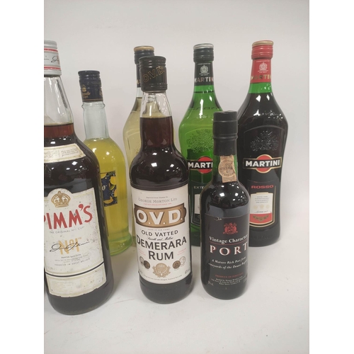 224 - Eleven bottles of assorted spirits and liqueurs to include bottles of Martini, 15% vol, 100cl, Pimms... 