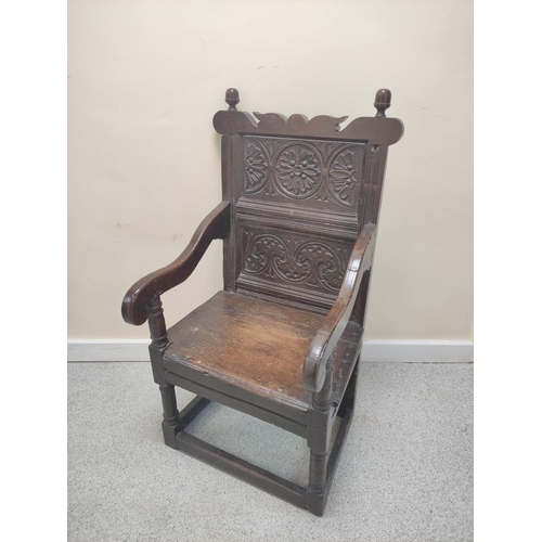 399 - 17th century wainscot chair, the foliate carved panel back with acorn finials, above solid seat, sha... 