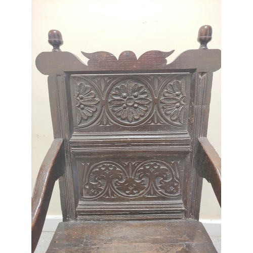 399 - 17th century wainscot chair, the foliate carved panel back with acorn finials, above solid seat, sha... 