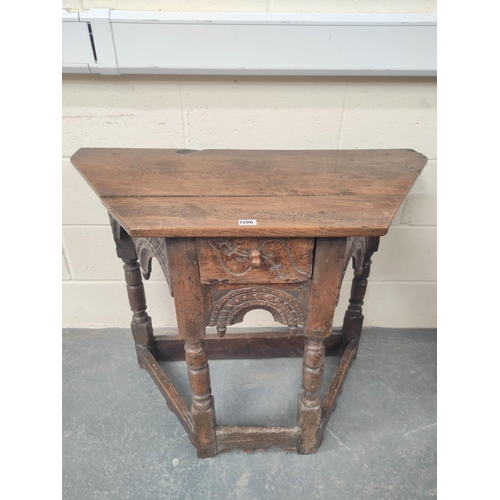 401 - 17th century style oak credence table, the shaped top above carved decoration, raised on turned legs... 