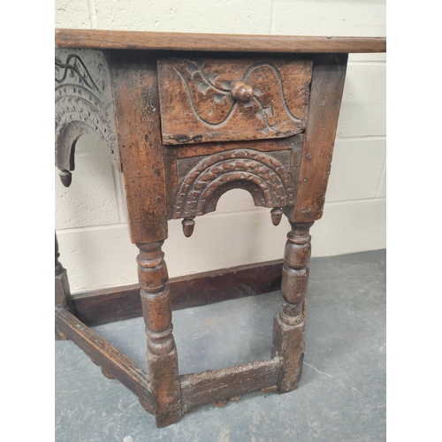 401 - 17th century style oak credence table, the shaped top above carved decoration, raised on turned legs... 