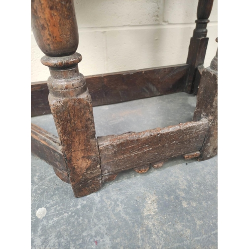 401 - 17th century style oak credence table, the shaped top above carved decoration, raised on turned legs... 